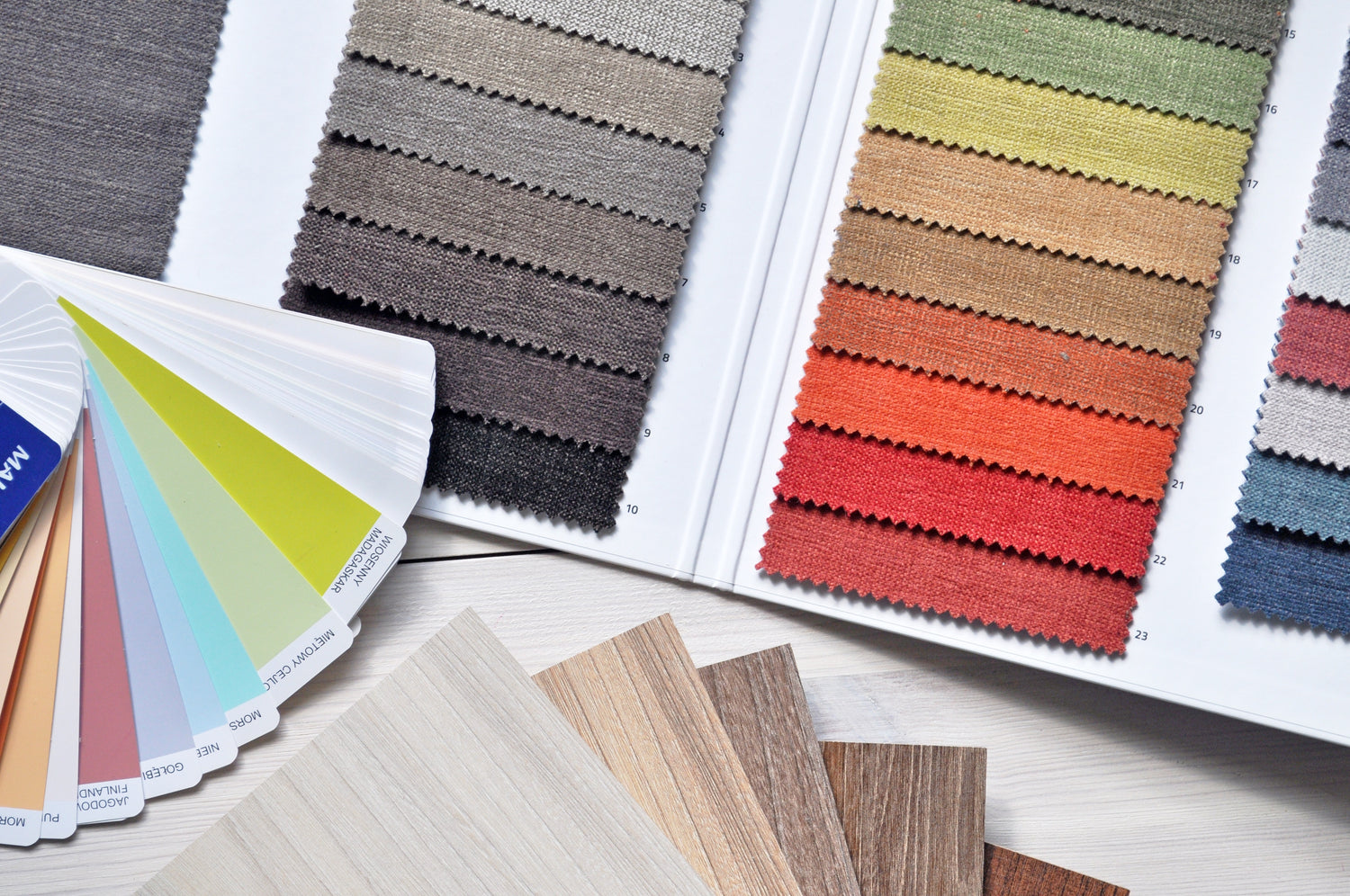 overhead photo of colour swatches, wood floor samples and fabric samples